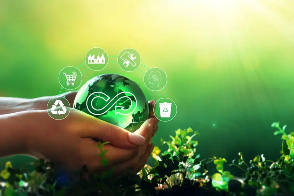 A person holding a green globe with icons floating out of it.