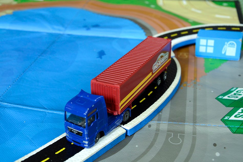 Toy truck driving on a toy track