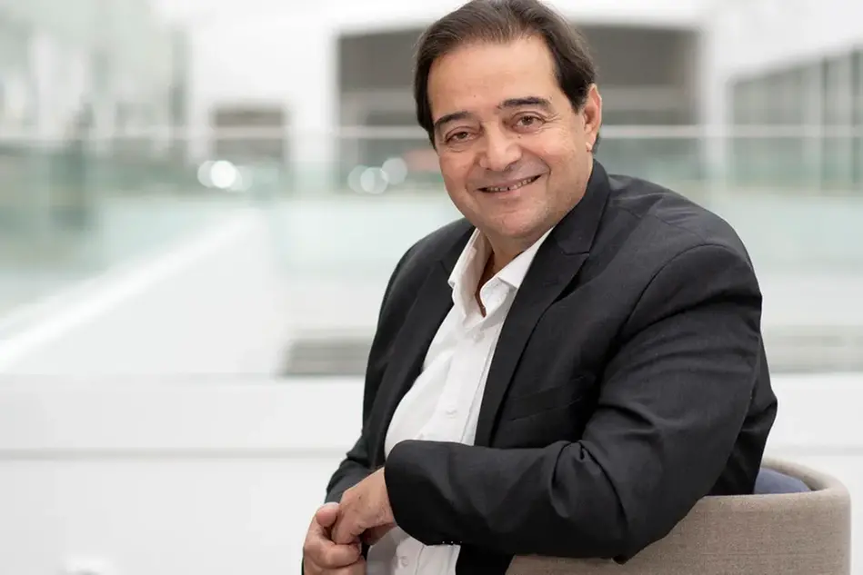 Portrait of a man in a white shirt and black blazer. Photo.