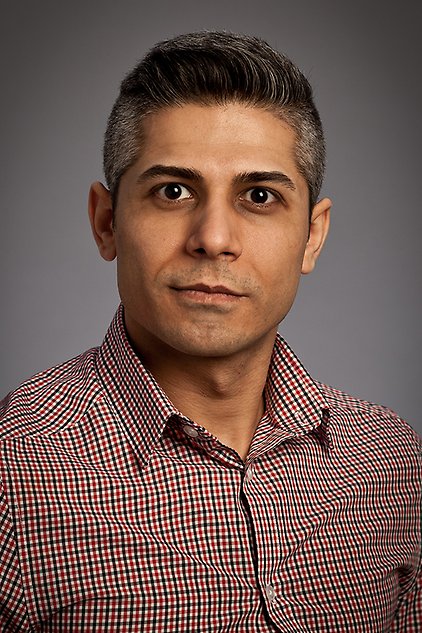 Headshot of a man against a grey background