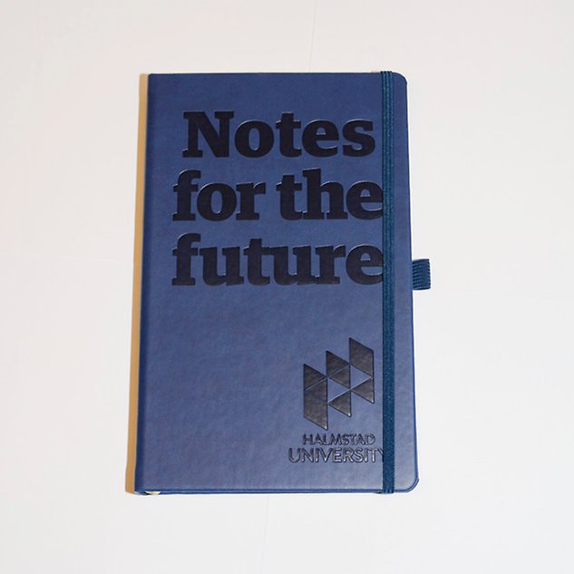 A dark blue notebook with the text ”Notes for the future” in English. Photo.
