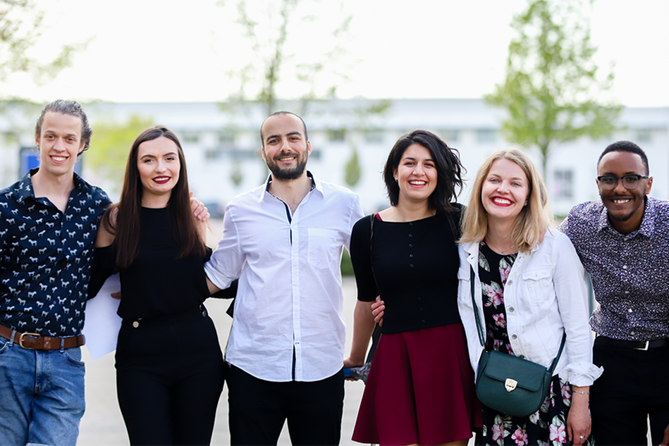 Six students standing outside Halmstad University. Photo.