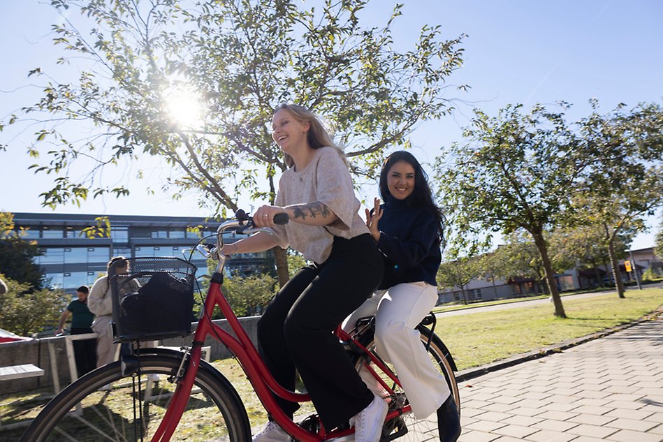 Two young people on a bicycle.